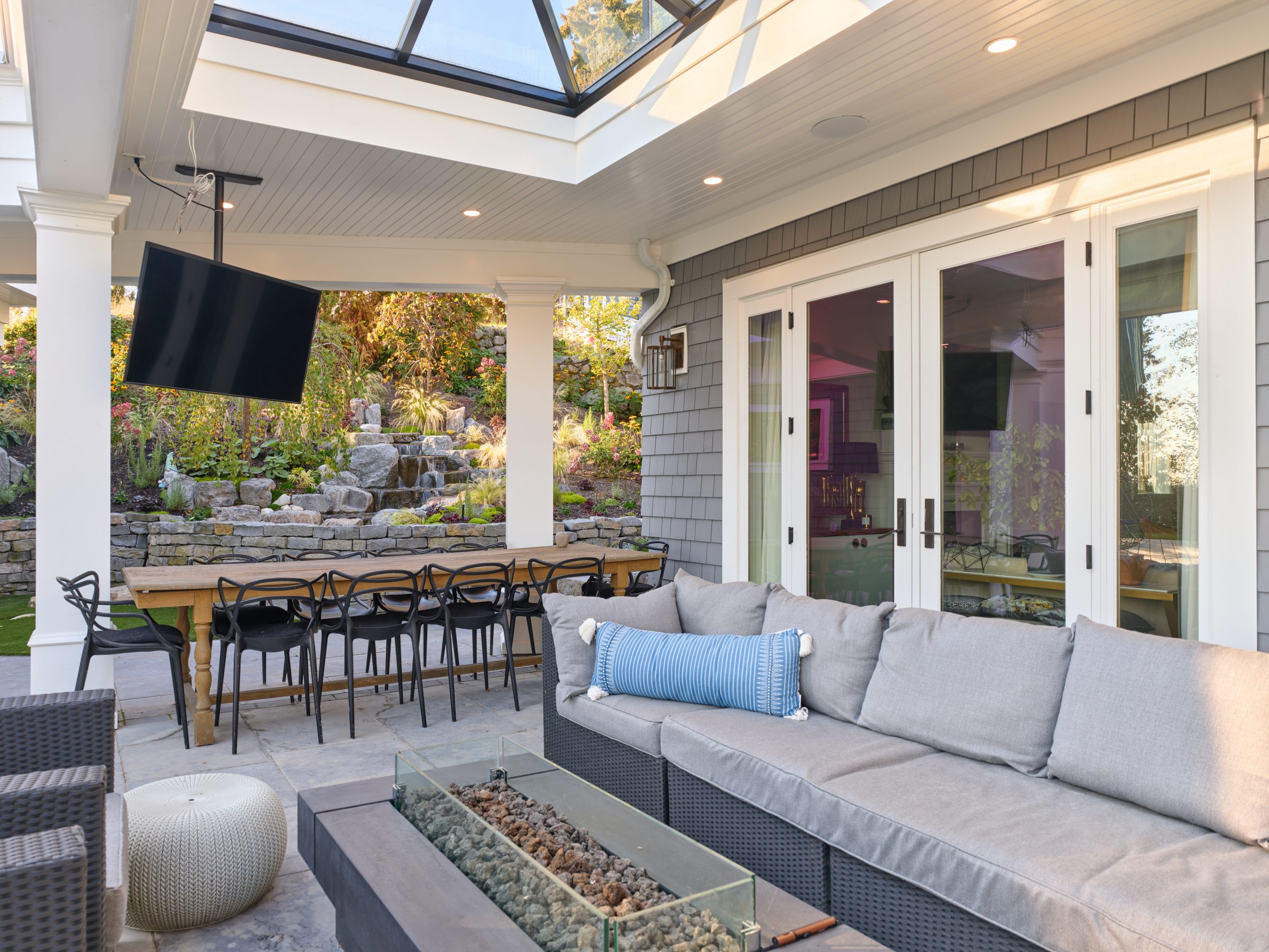 Covered patio with outdoor seating and waterfall