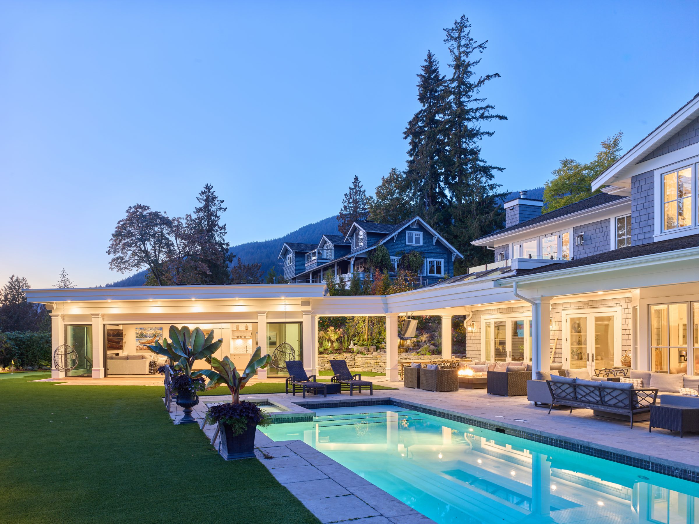 Luxury home with pool and patio at dusk