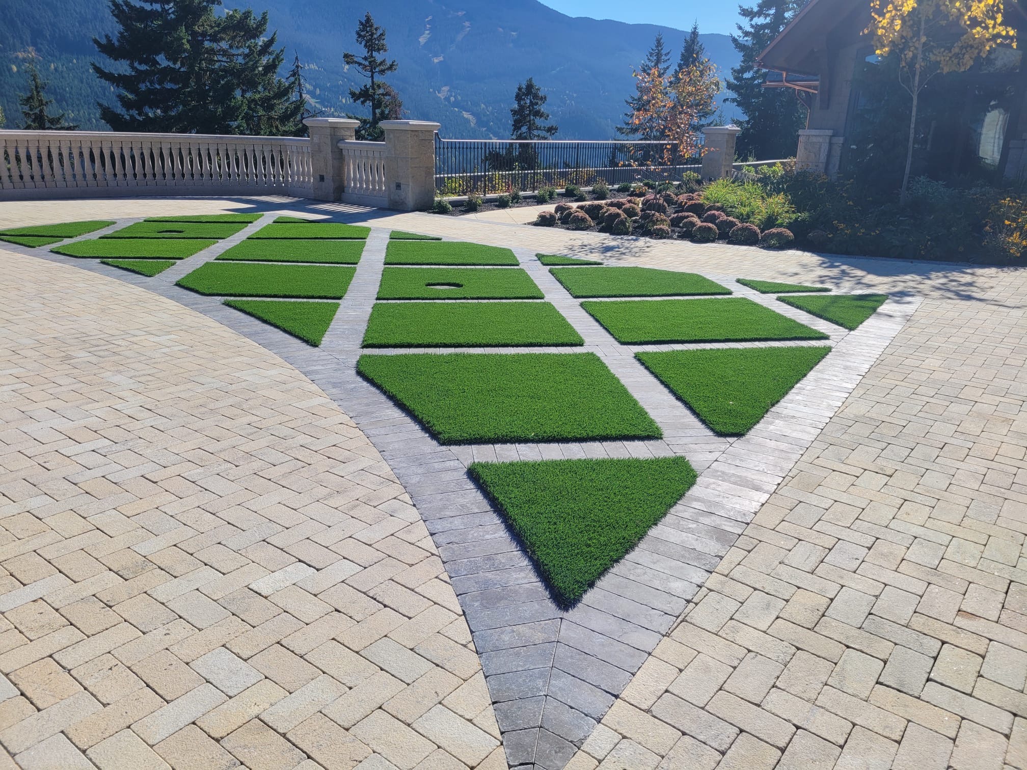 Geometric artificial turf patio overlooking mountain landscape