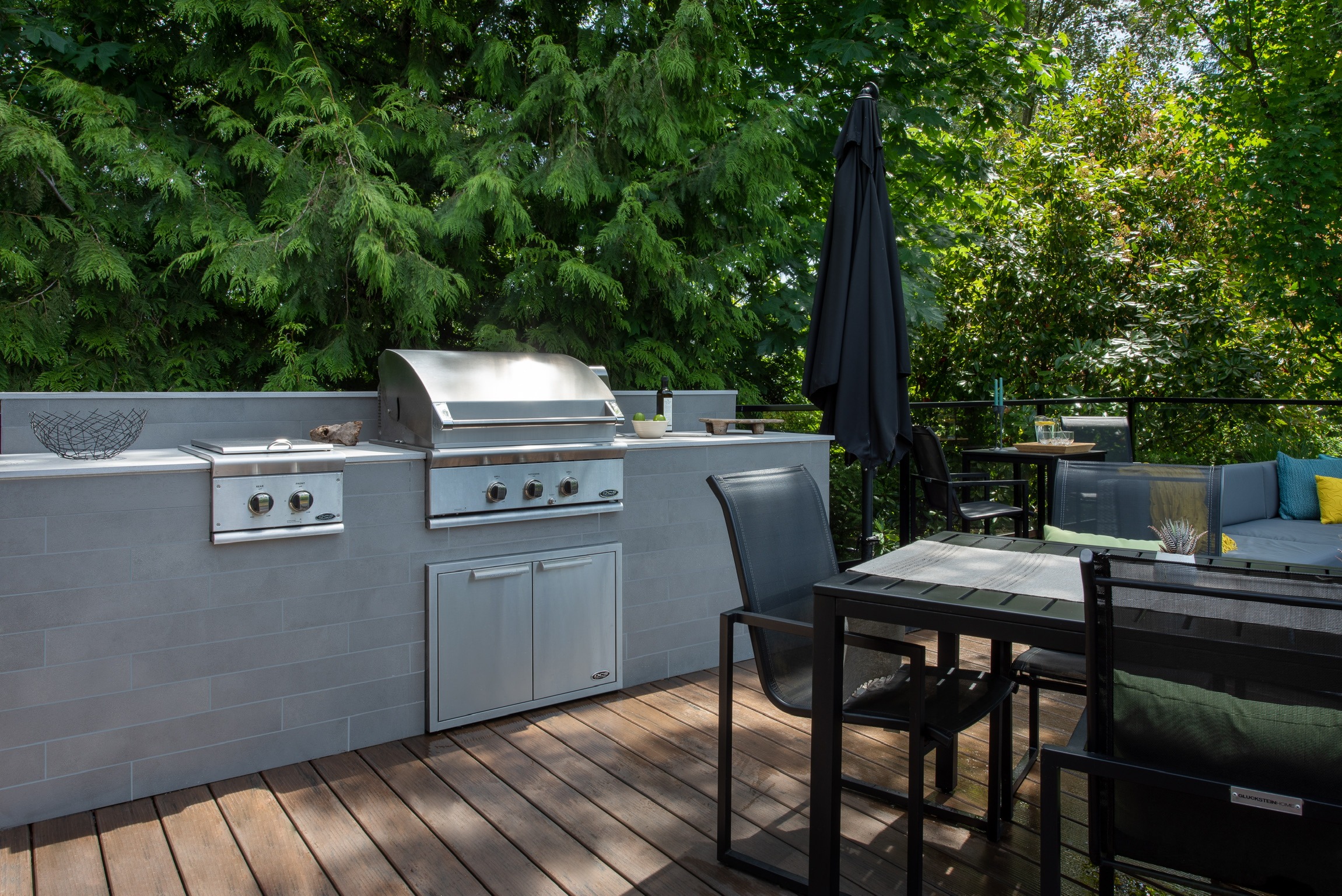 Modern outdoor kitchen with grill and patio seating
