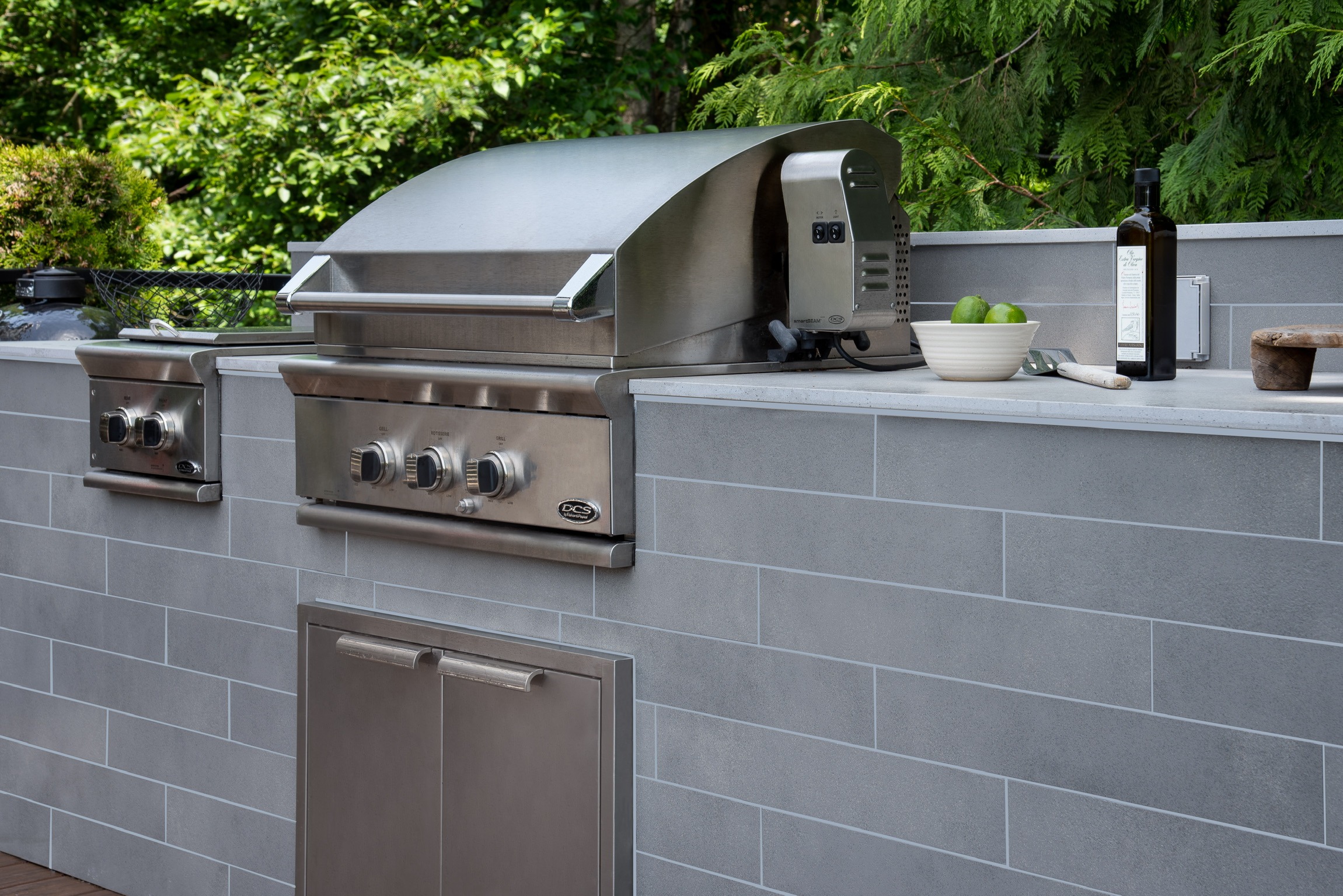 Stainless steel outdoor grill in modern backyard kitchen