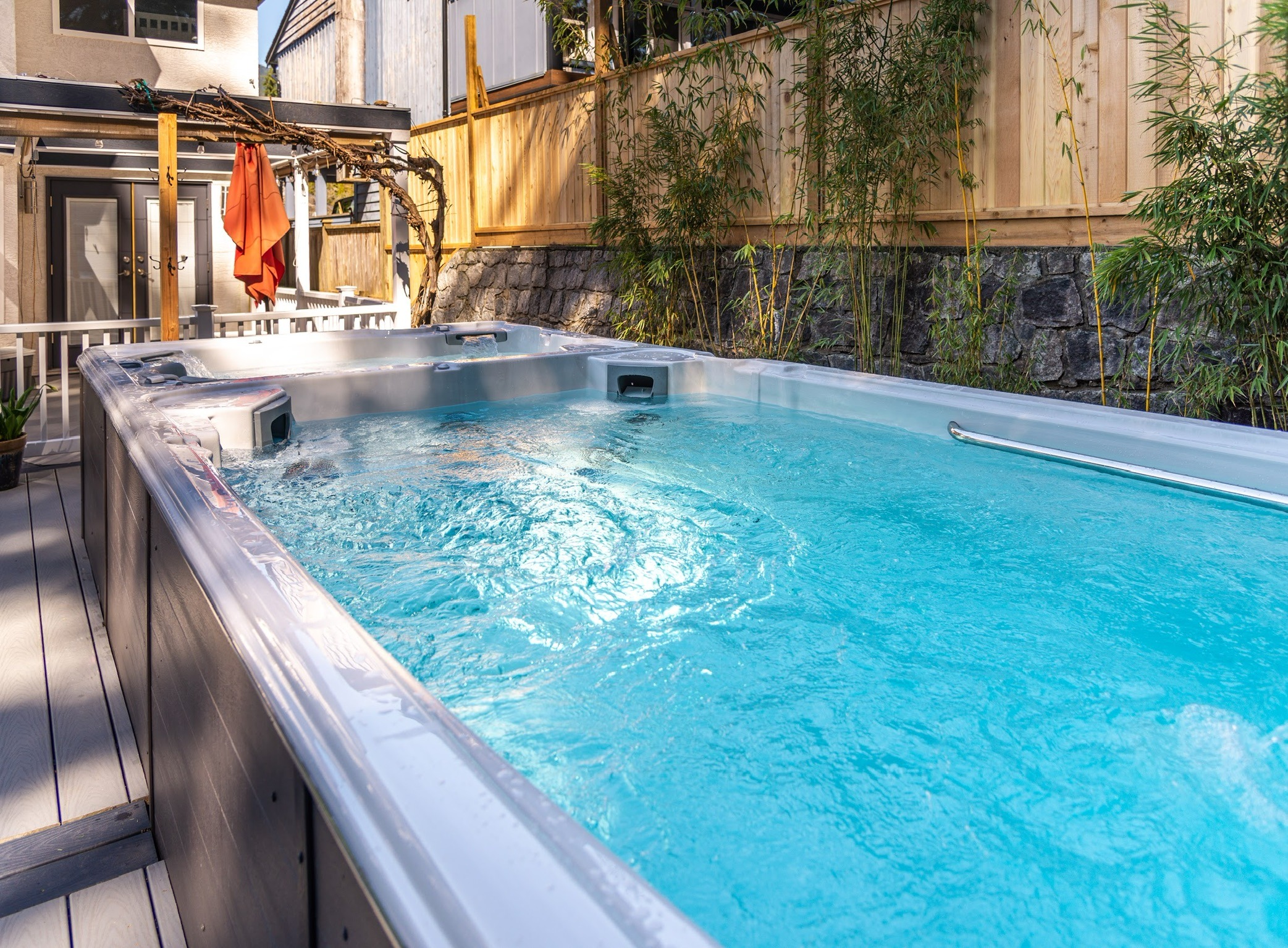 Modern backyard swim spa with bubbling water