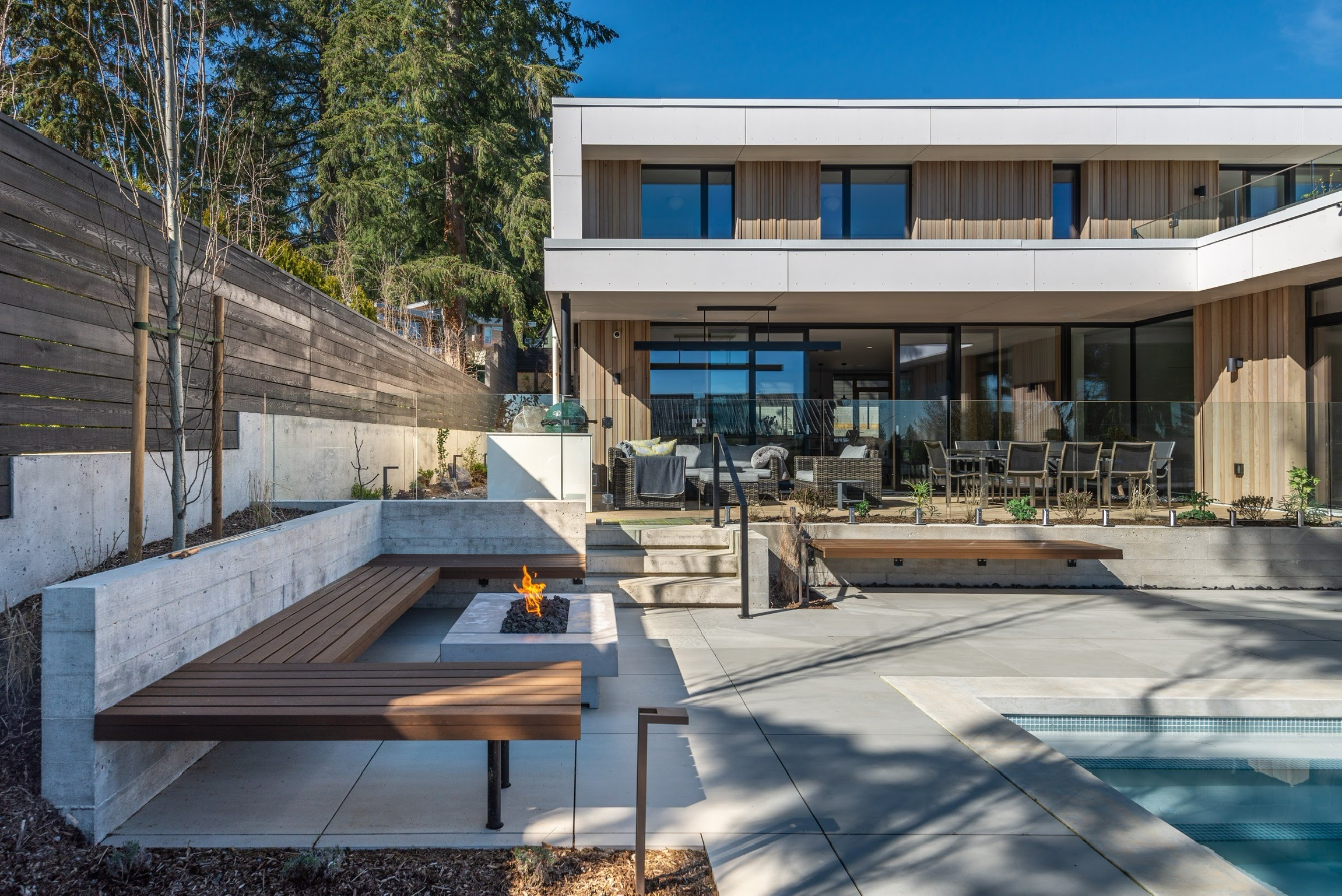 Modern home patio with fire pit and pool