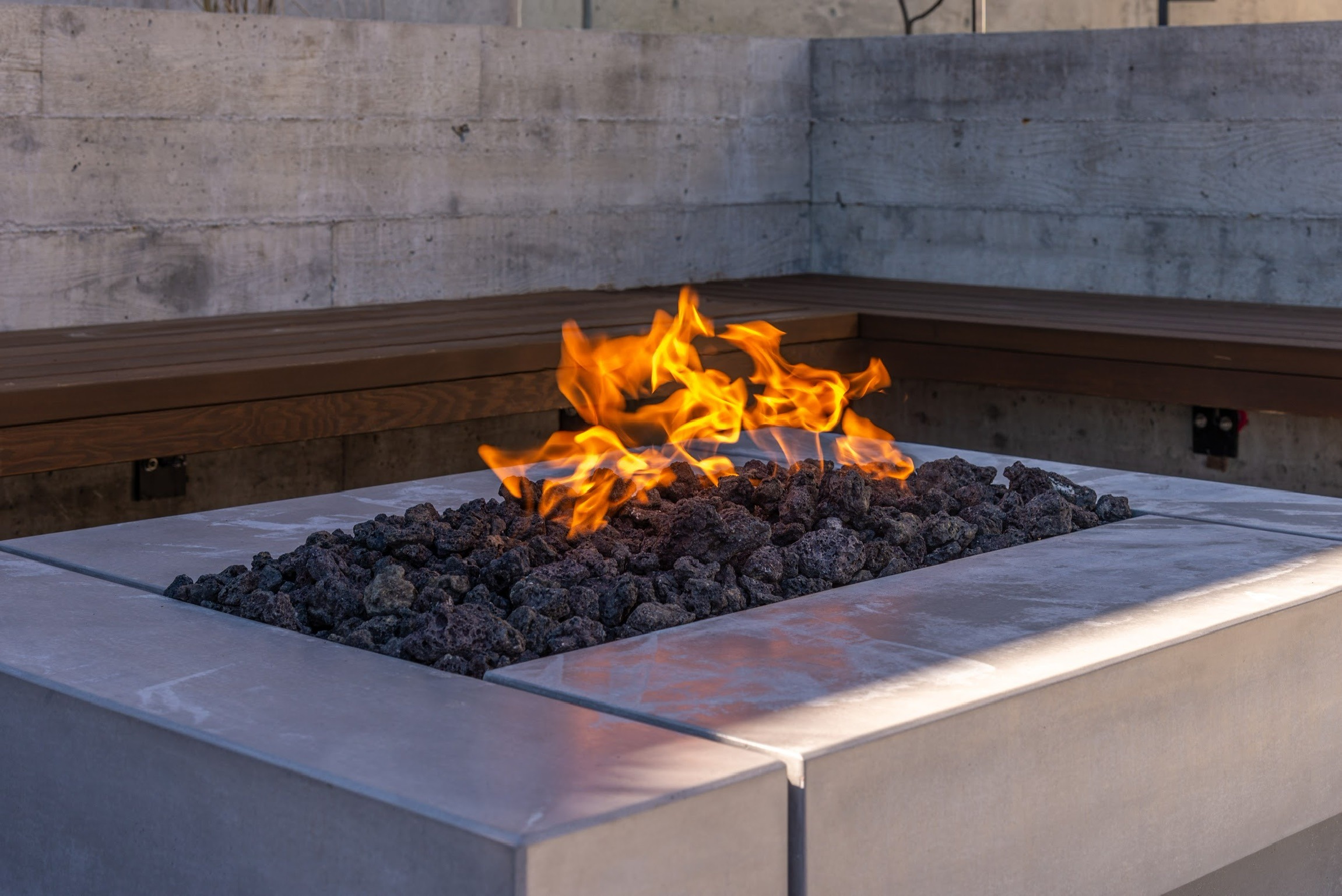 Modern outdoor fire pit with lava rocks