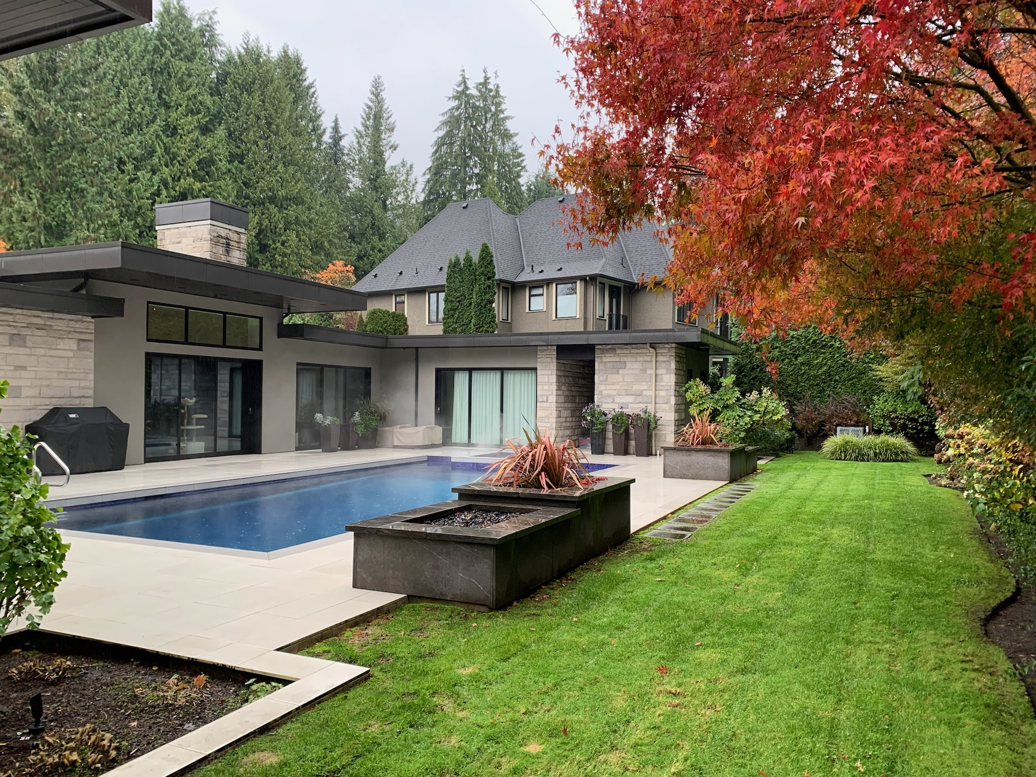 Modern home with pool and autumn garden
