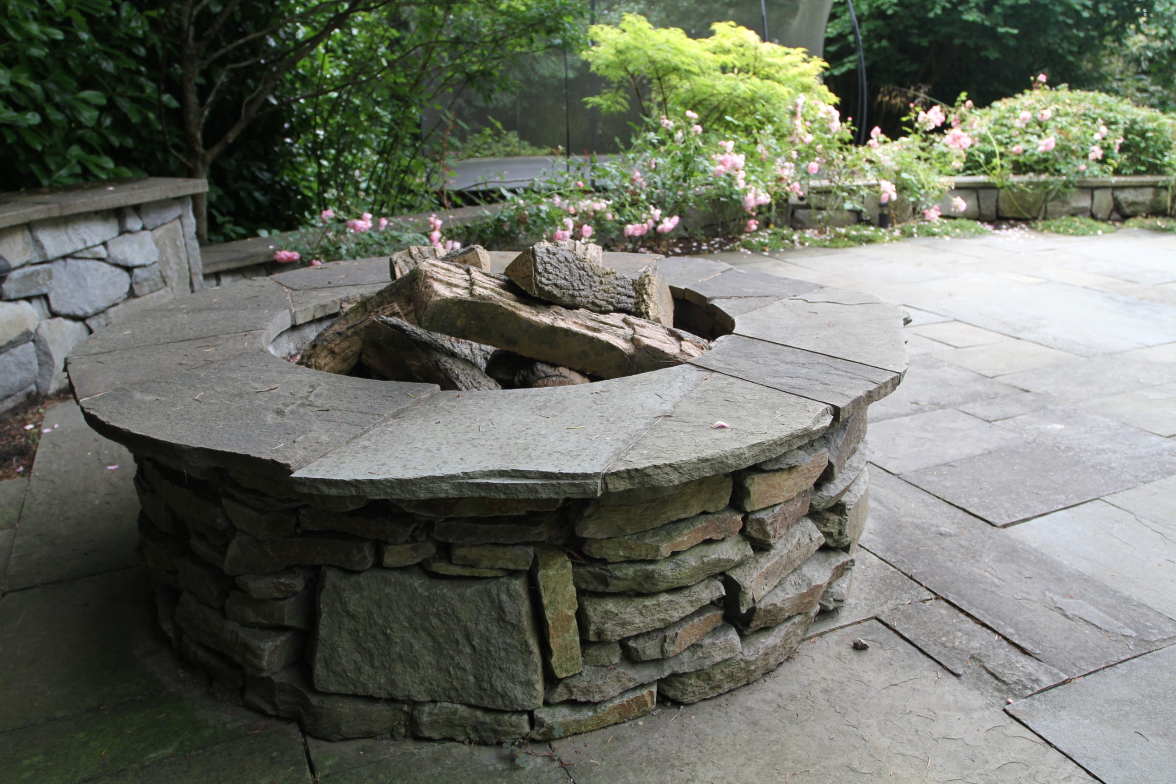 Stone fire pit on backyard patio