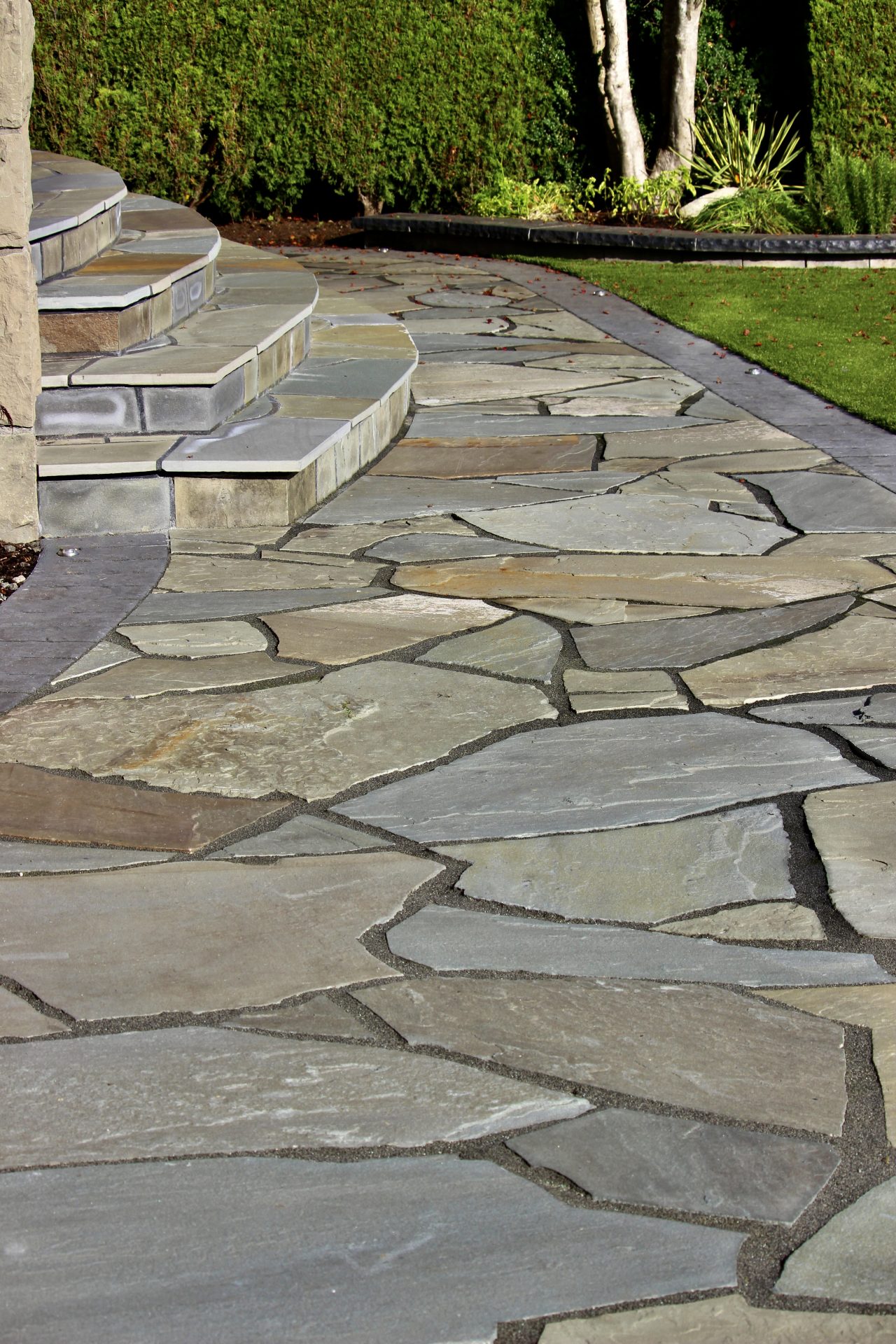 Flagstone patio walkway with curved stone steps