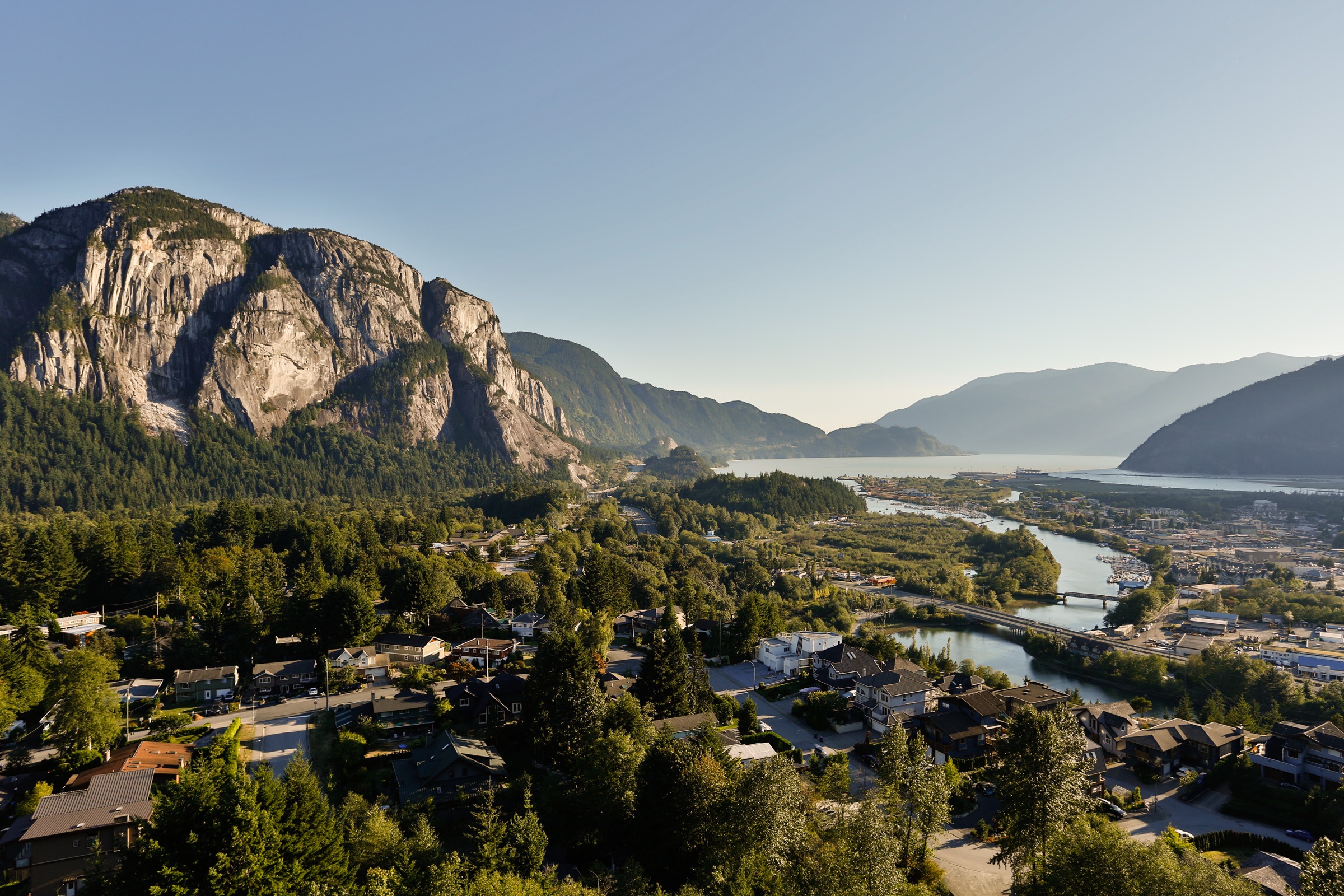 Mountain cliff overlooking river and small town