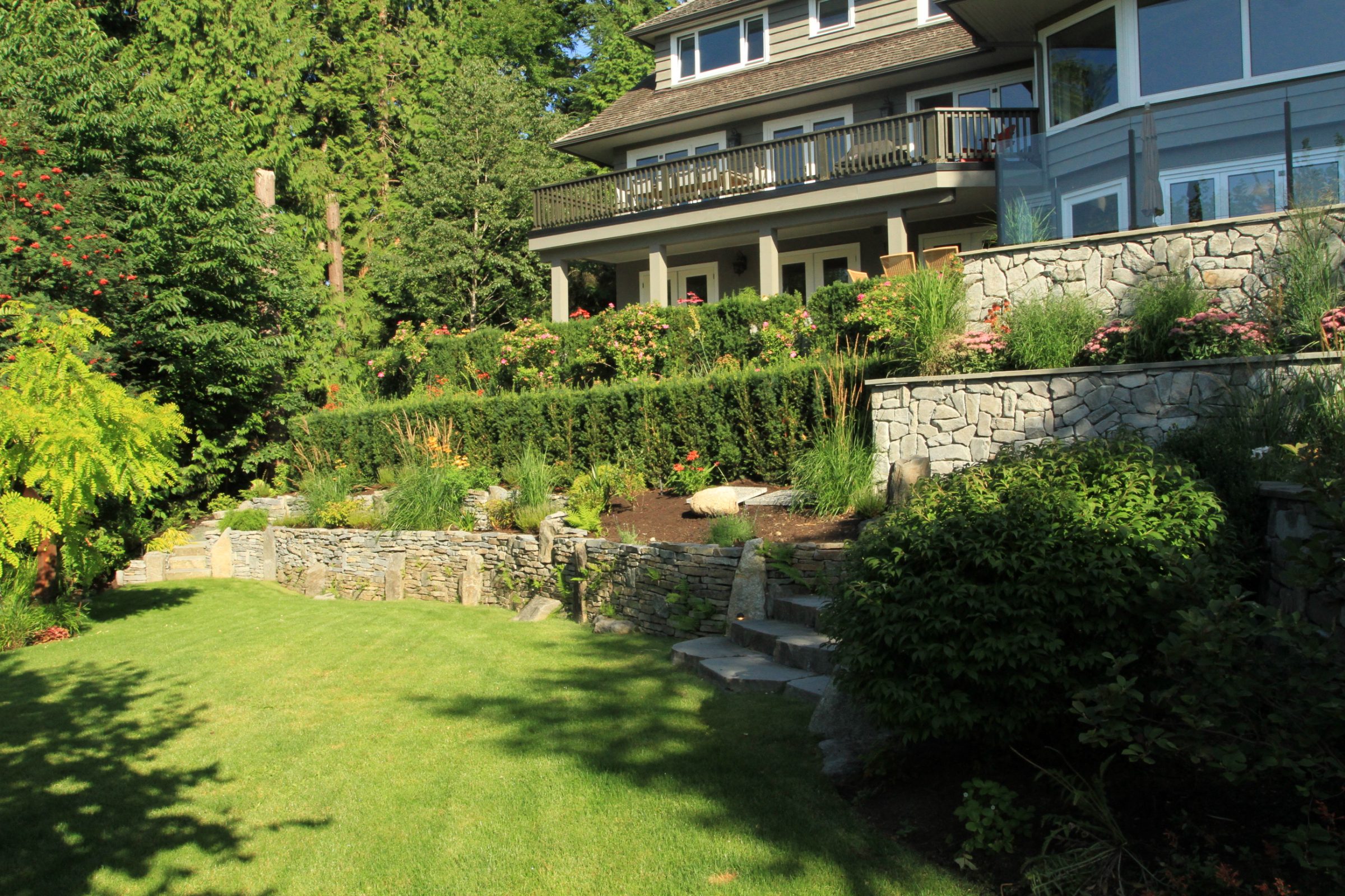 Modern house overlooking terraced garden and lawn
