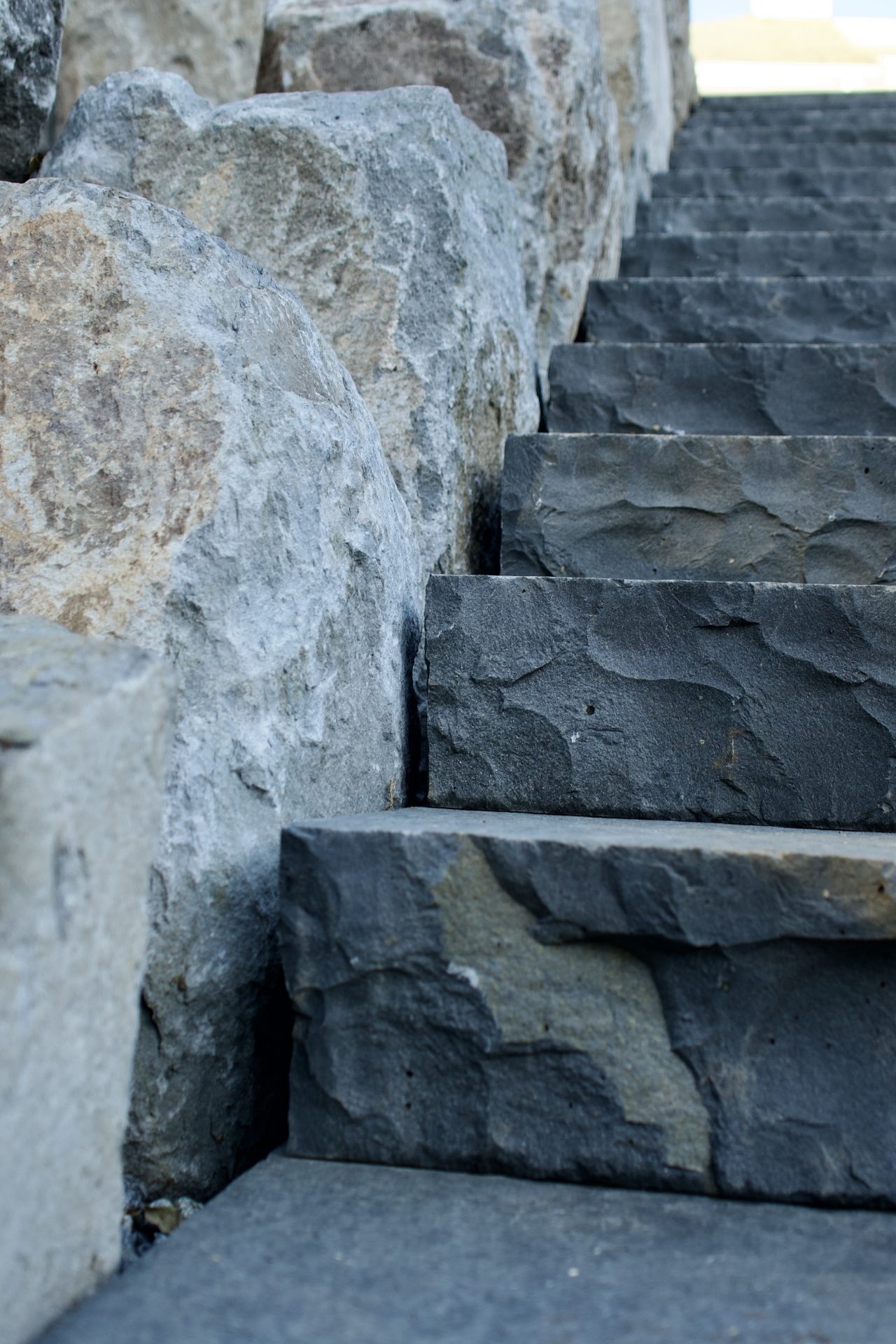 Stone staircase beside rough stone wall
