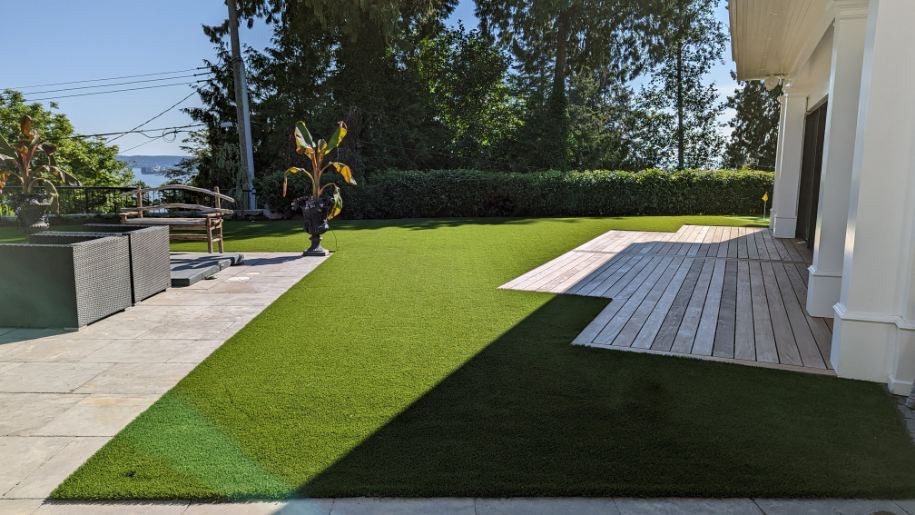 Modern backyard with artificial turf and wooden deck