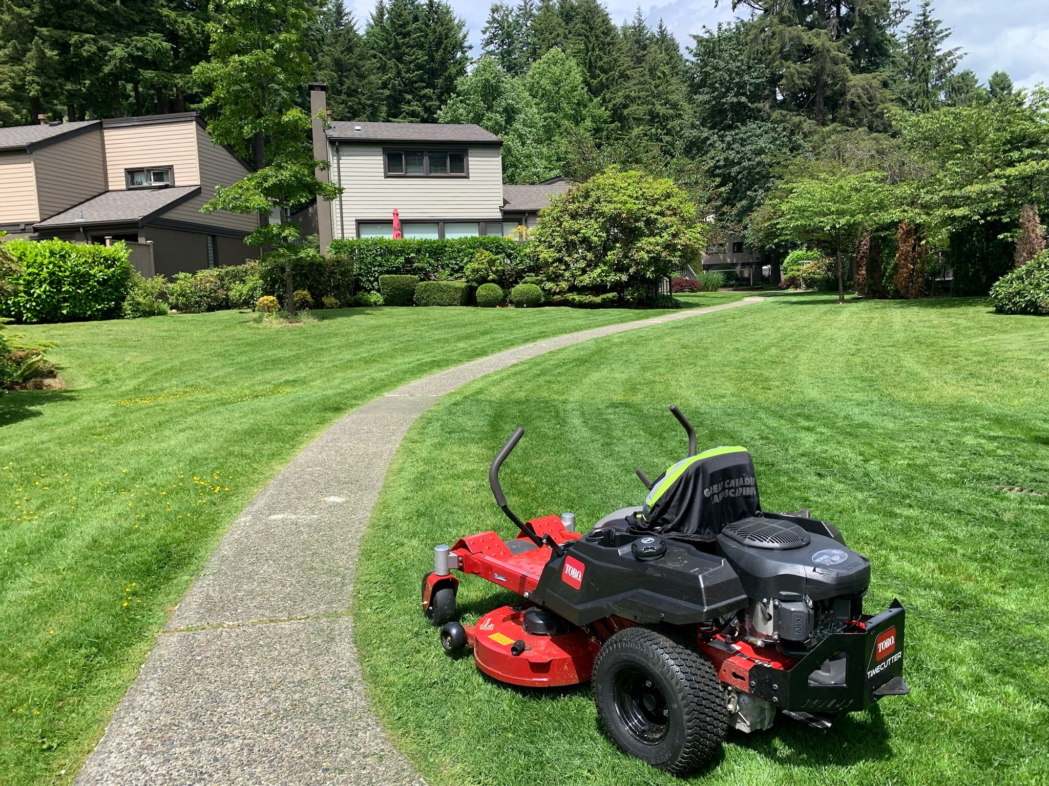 Lawn mower on manicured residential green lawn