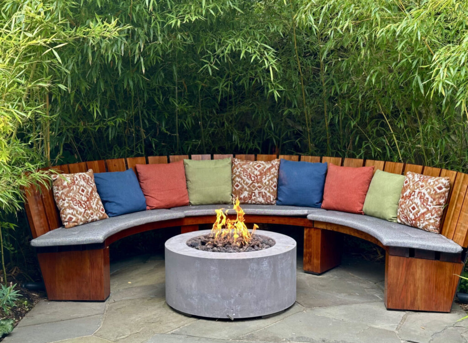 Curved outdoor bench around modern fire pit
