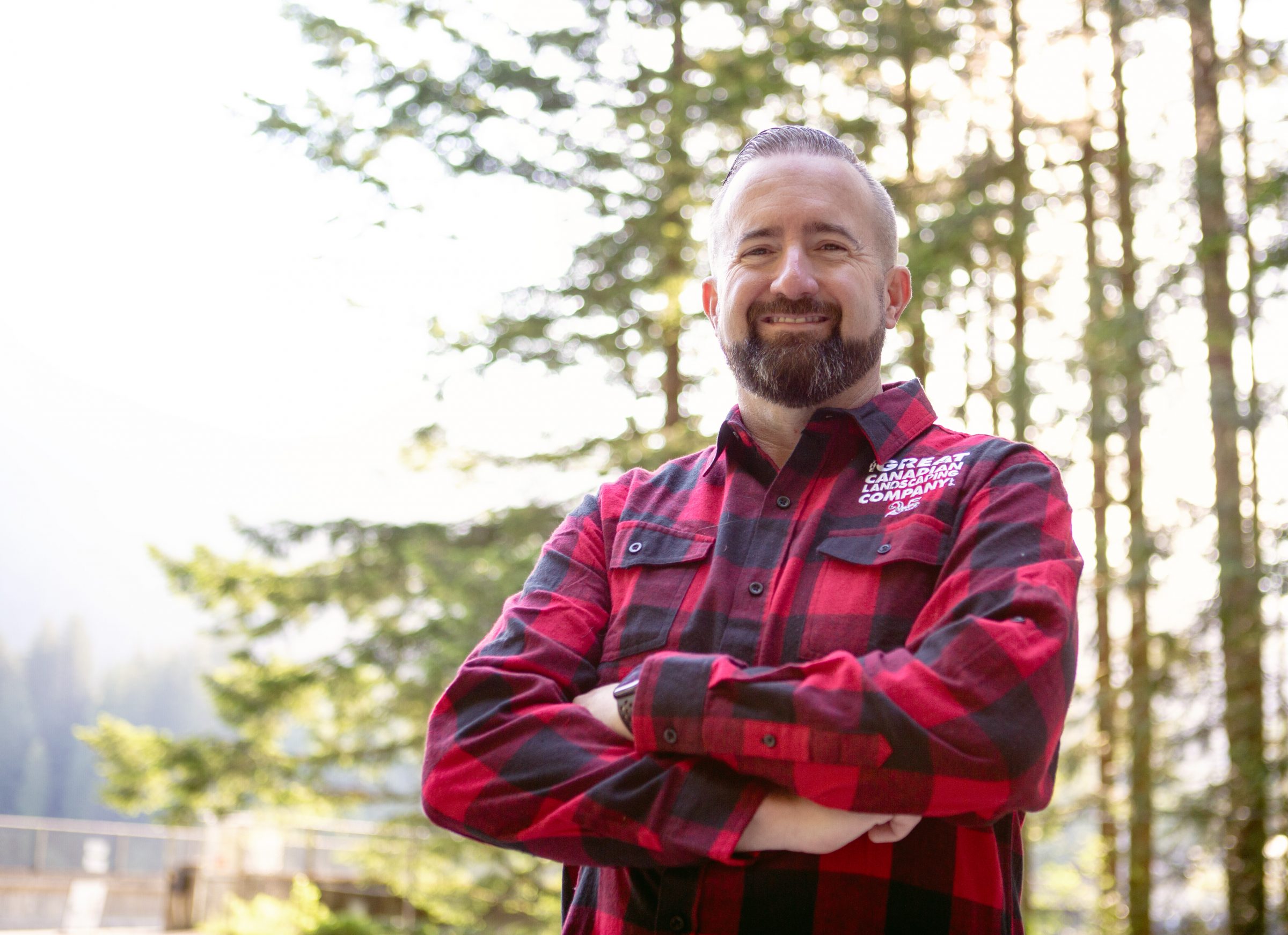 Smiling man in red plaid outdoors