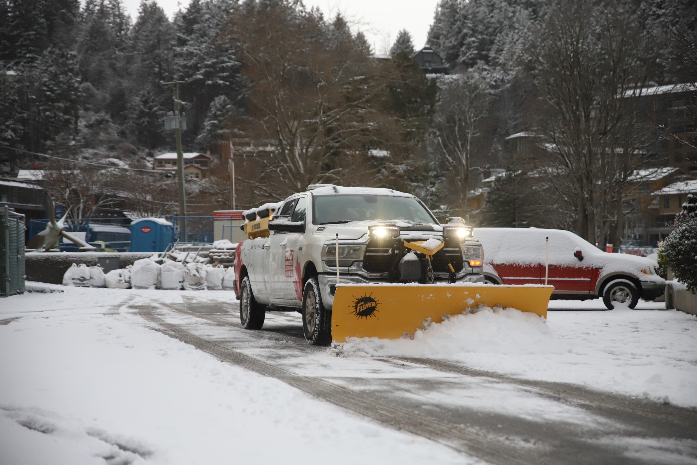 Pickup truck plowing snow in residential neighborhood
