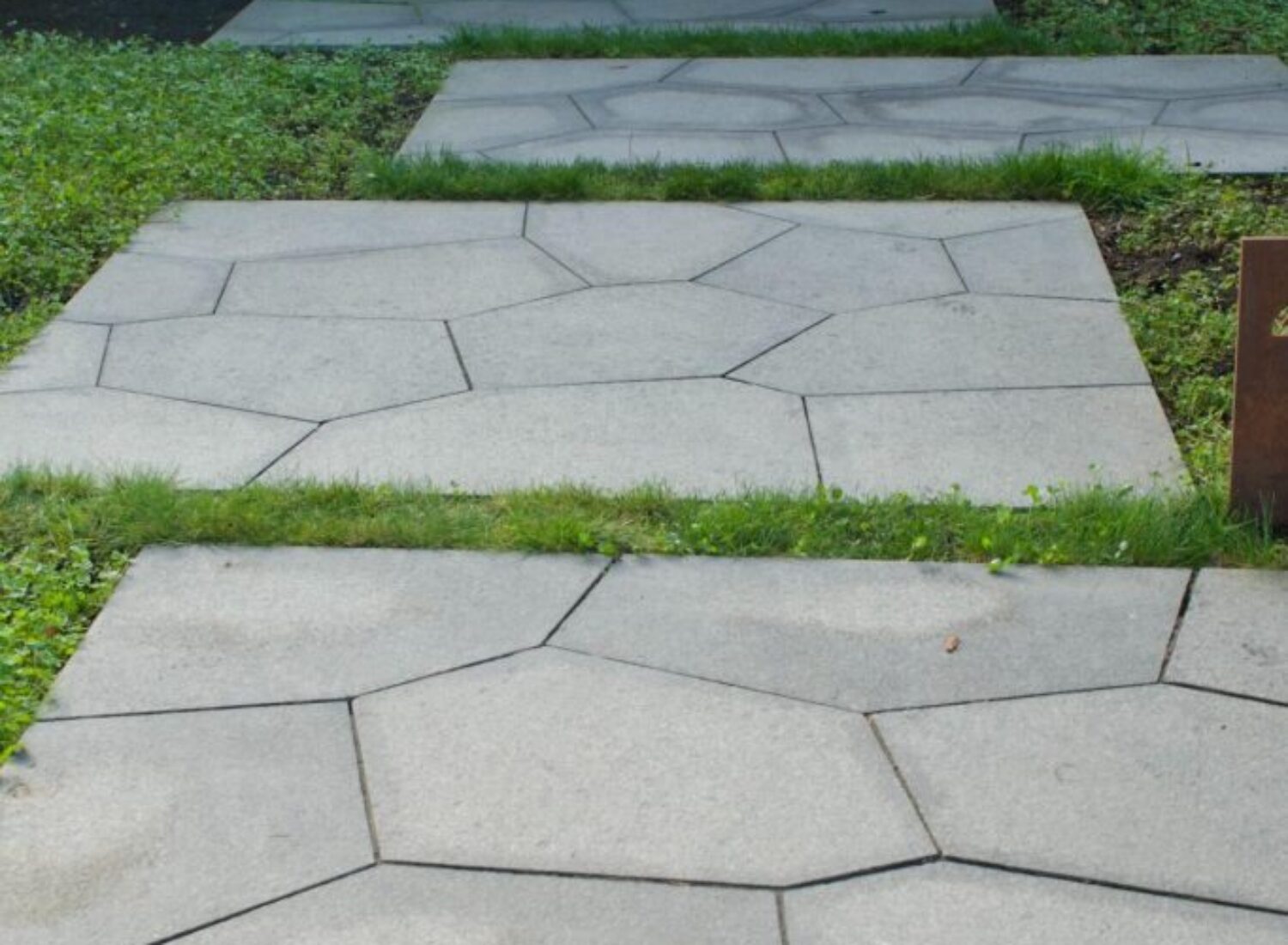 Concrete stepping stone path with grass borders