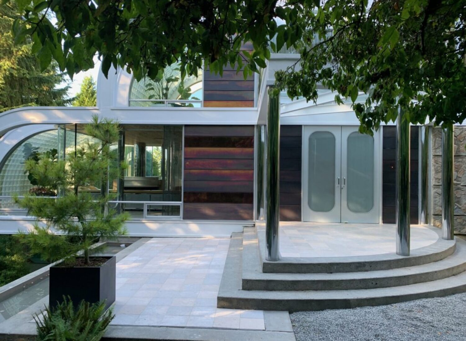 Modern house exterior with curved glass and columns