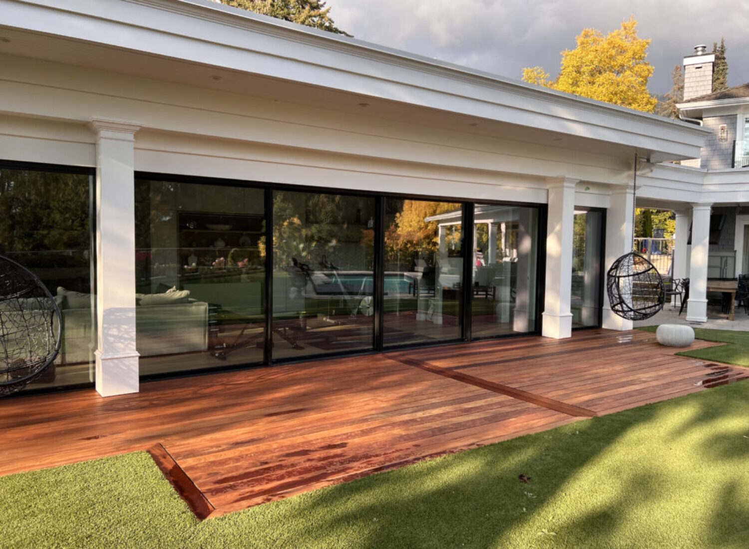 Modern home with wooden deck and glass doors
