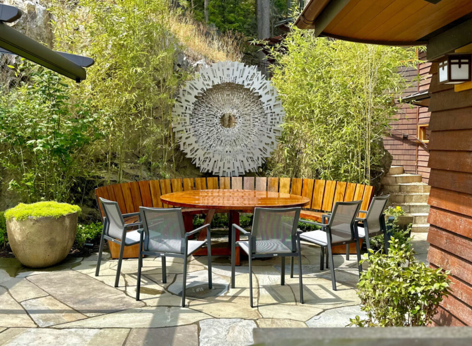 Modern outdoor patio with round table and bamboo