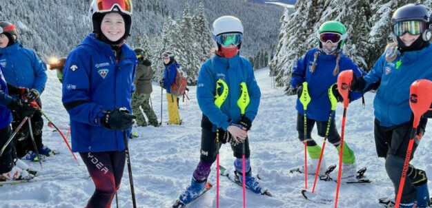 Children in ski gear on snowy mountain slope