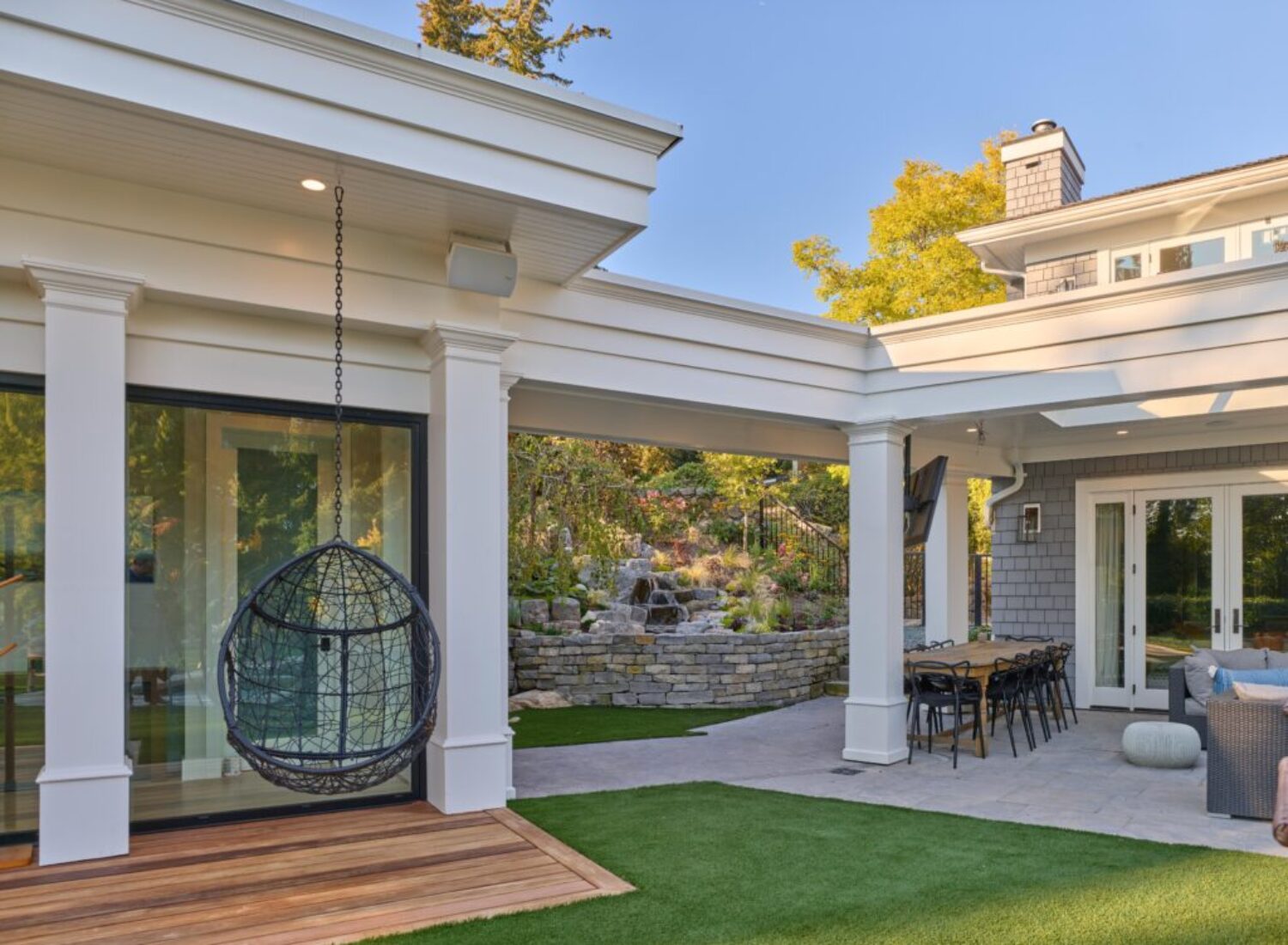 Modern backyard patio with hanging egg chair