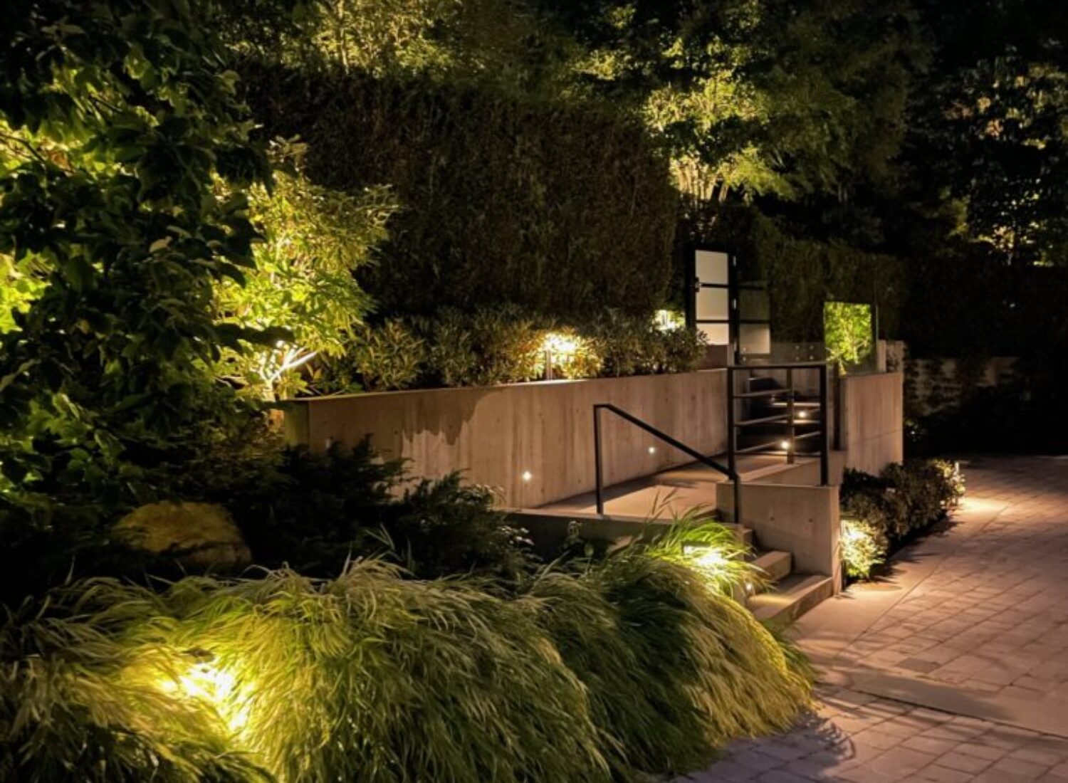 Modern garden entrance illuminated at night