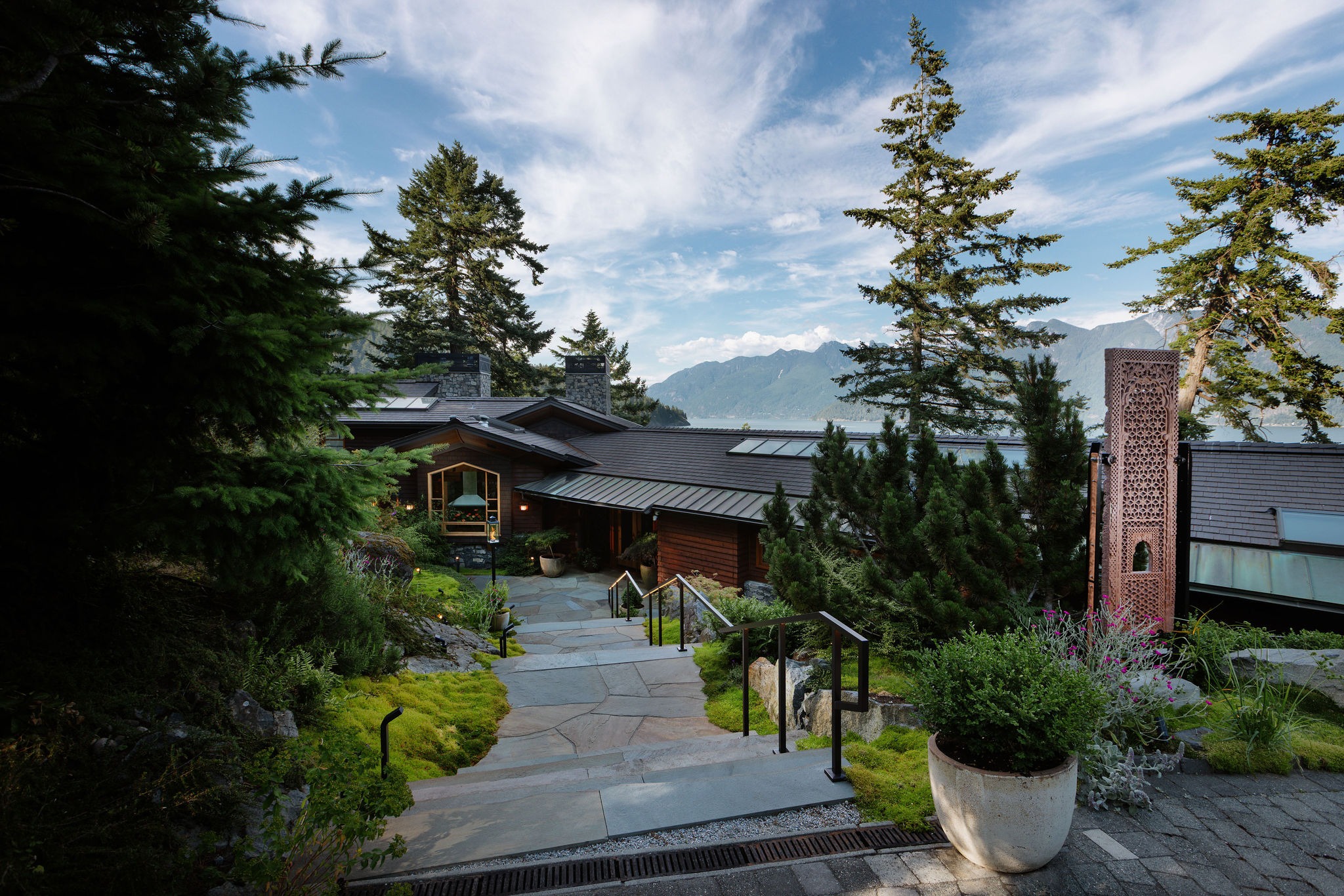 Modern mountain home overlooking lake and forest