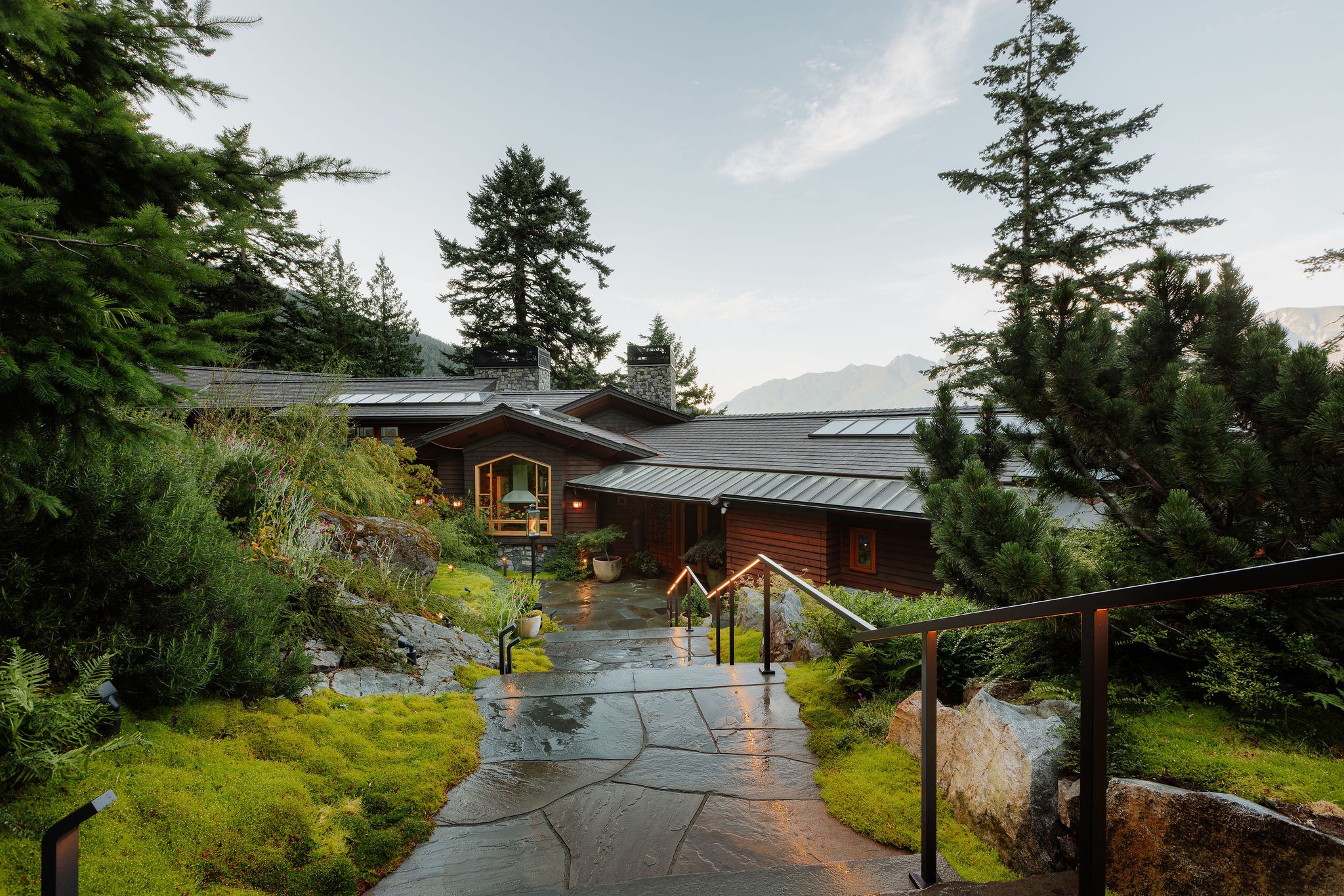 Modern mountain home surrounded by lush forest