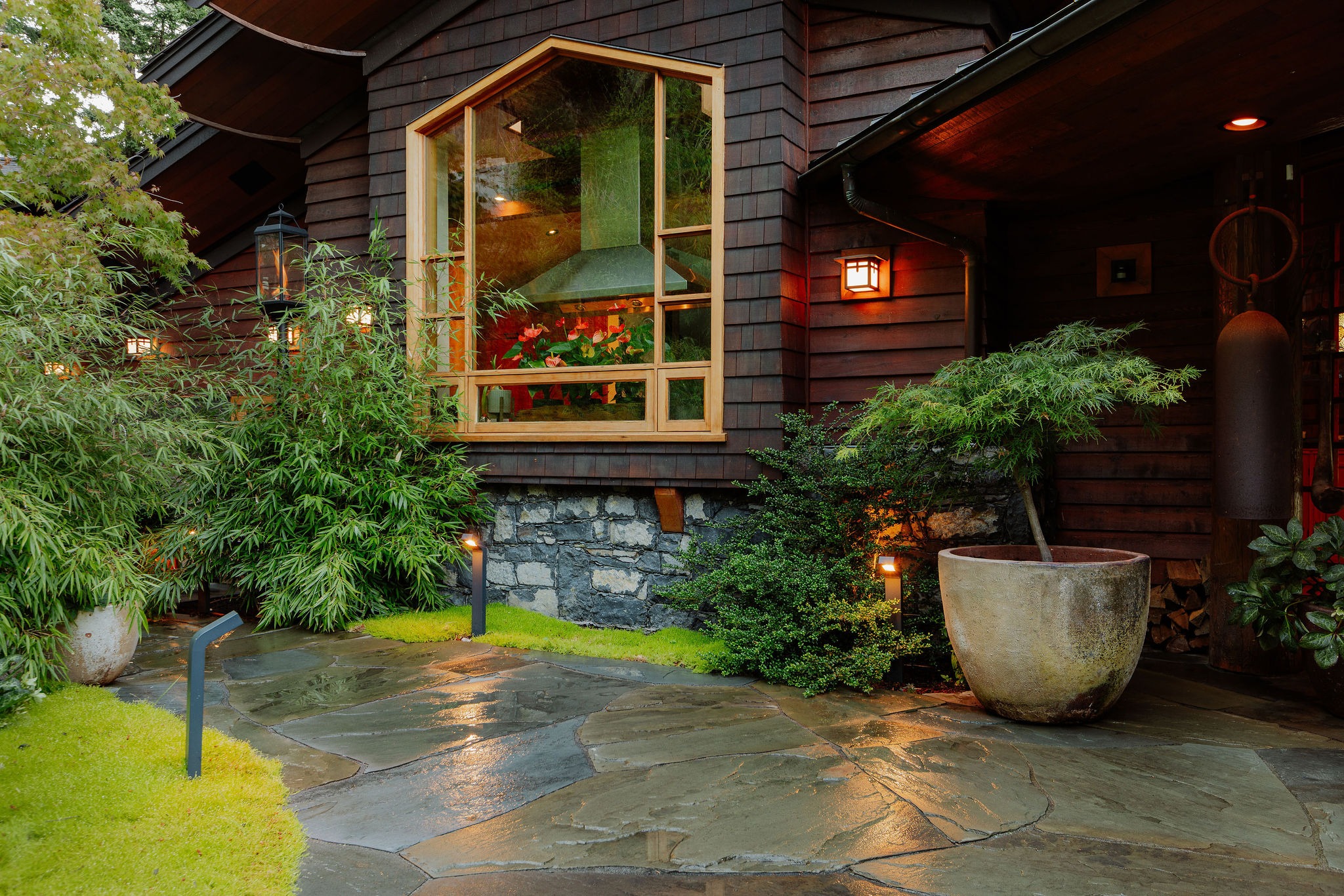 Modern wood house with lush garden patio