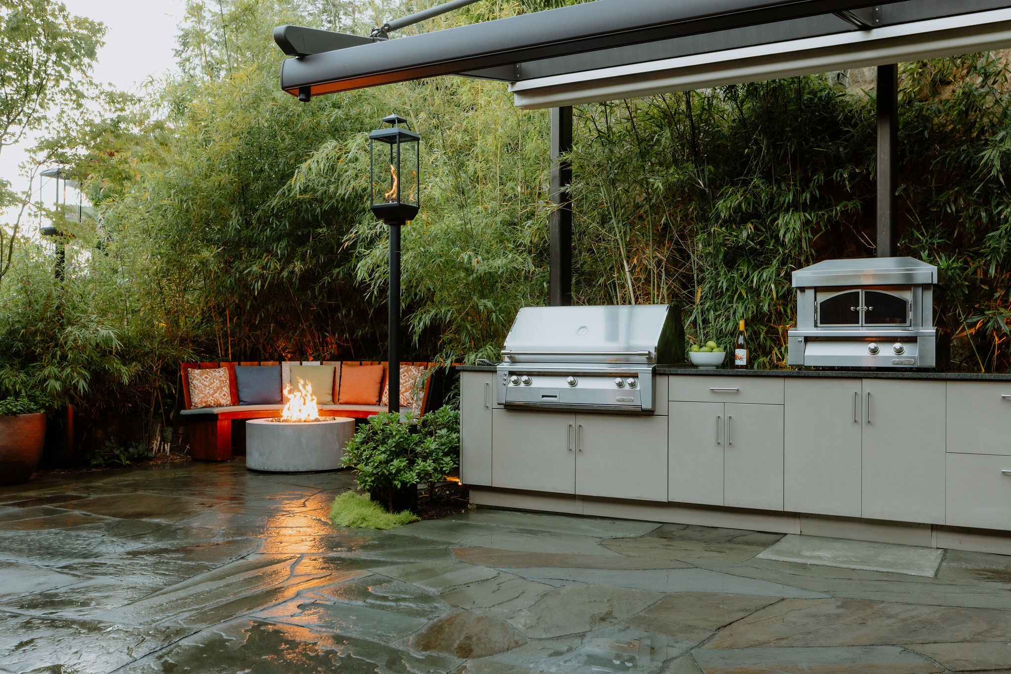 Modern outdoor kitchen with grill and fire pit
